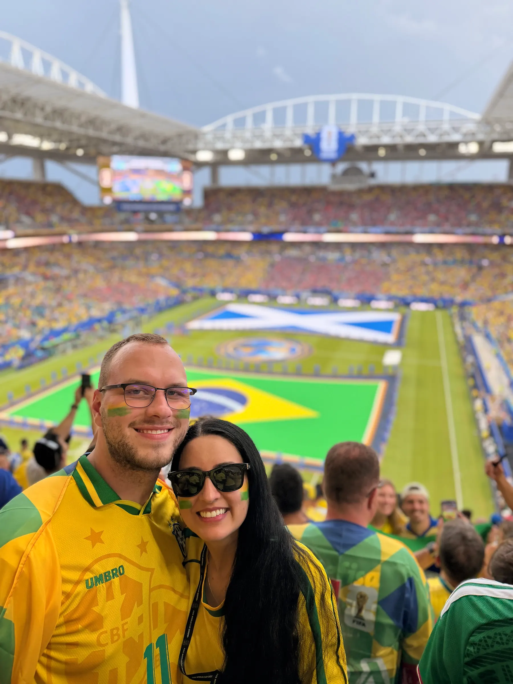 Tyler Henn and a companion wearing Brazil colors at a soccer match in Miami during the 2026 FIFA World Cup