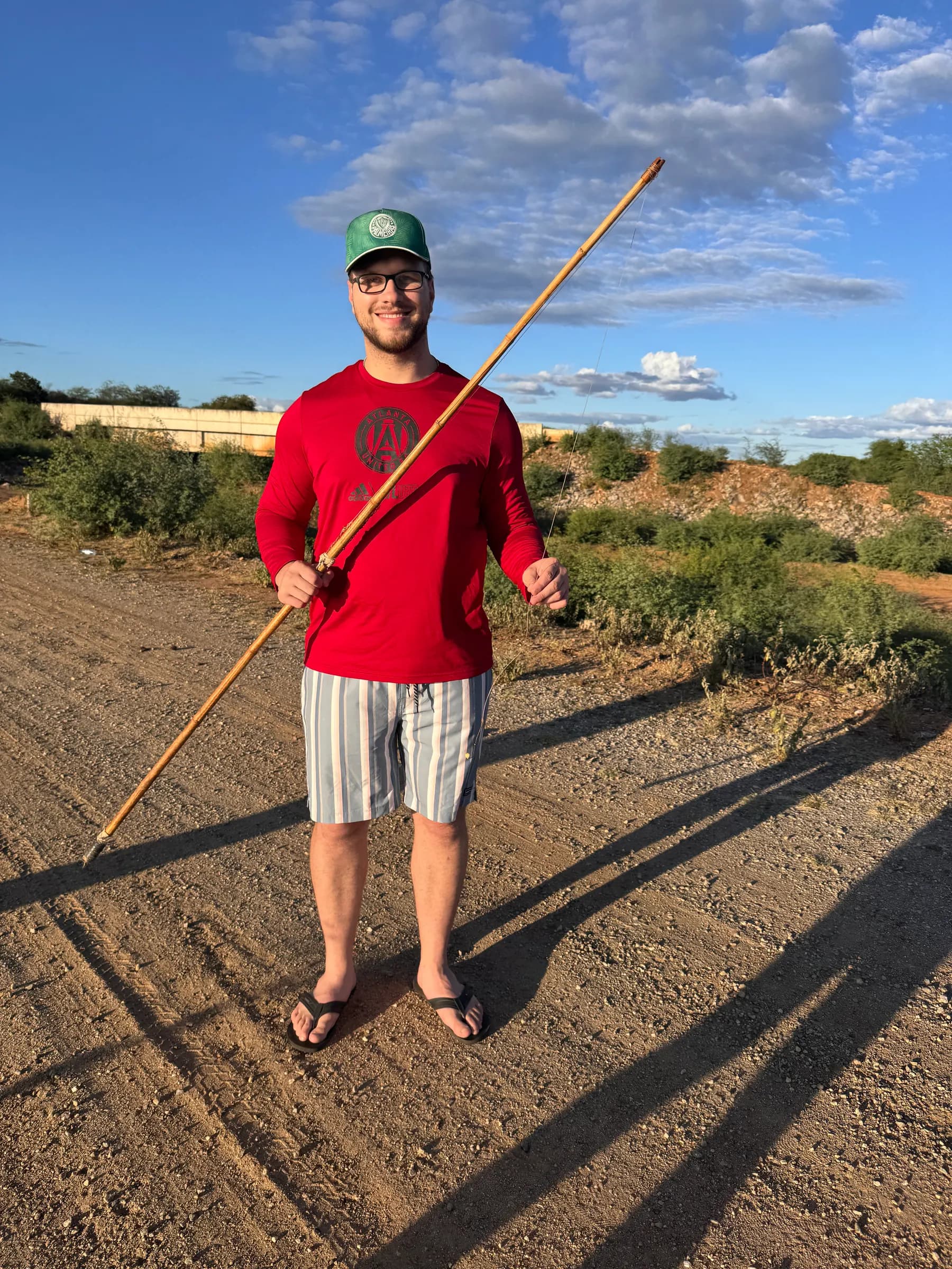 Tyler Henn fishing outdoors with a traditional long wooden rod in Pernambuco, Brazil