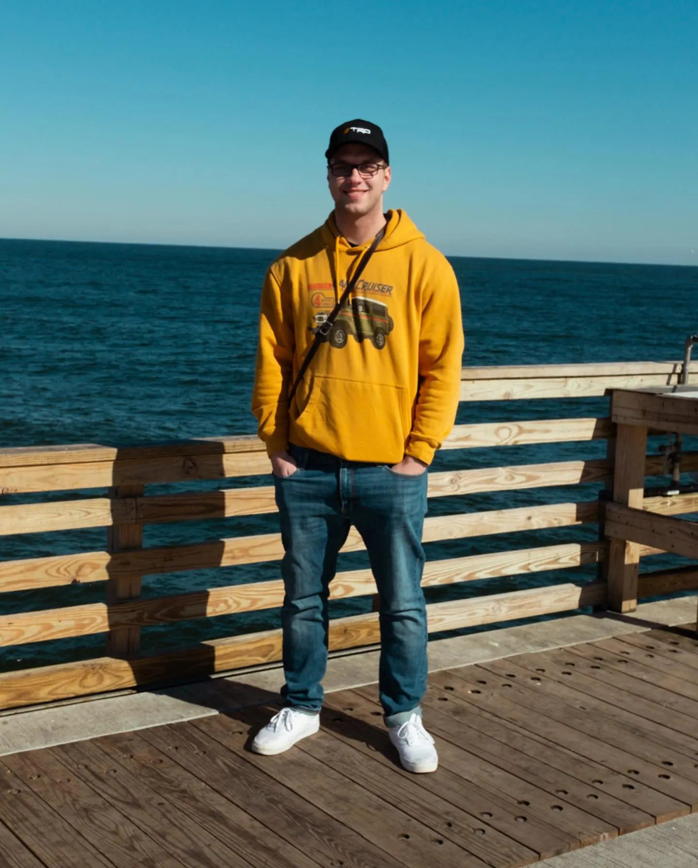 Tyler Henn standing on a wooden ocean pier in Ponte Vedra Beach, Florida