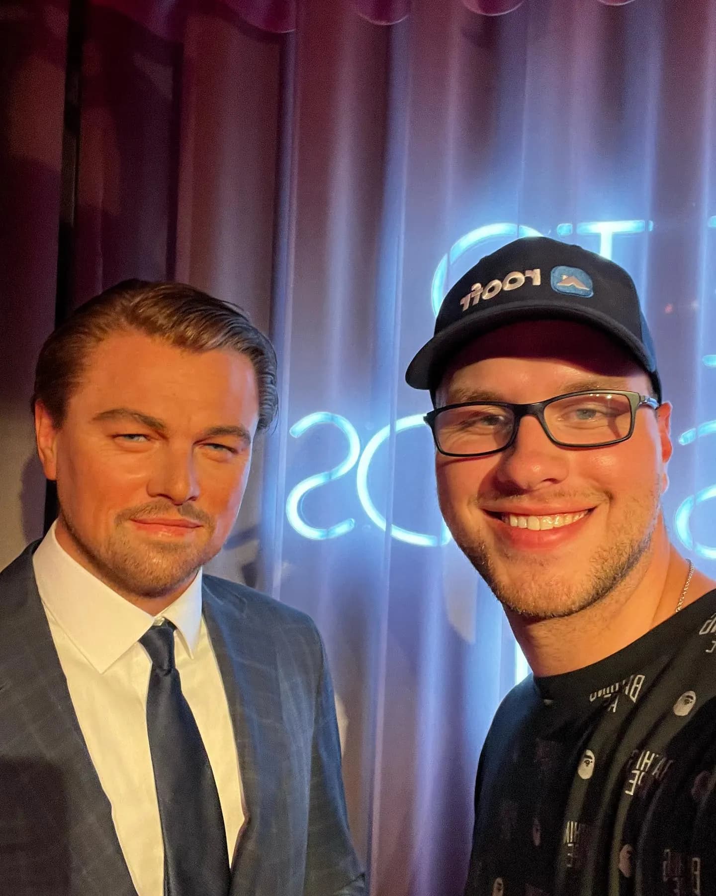 Tyler Henn taking a selfie beside a Leonardo DiCaprio wax figure